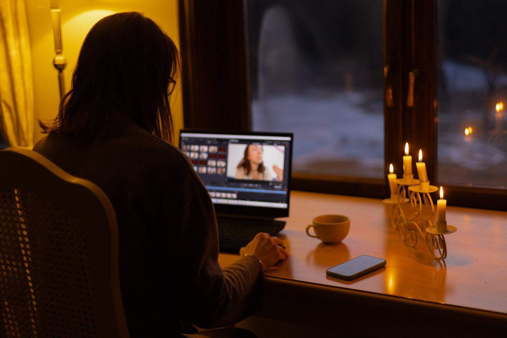 Woman working by candlelight cozy atmosphere